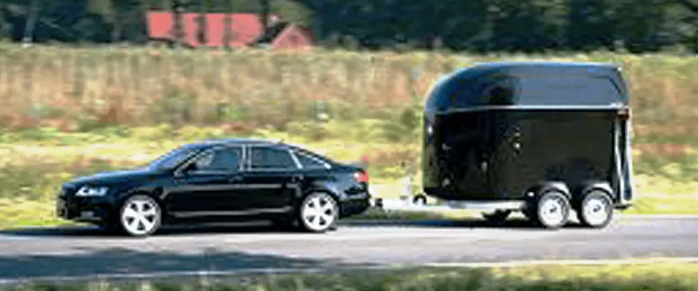 Picture of a car towing a horse bumper-pull horse trailer.