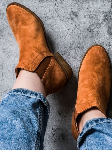 Picture of a woman wearing chelsea boots with jeans.