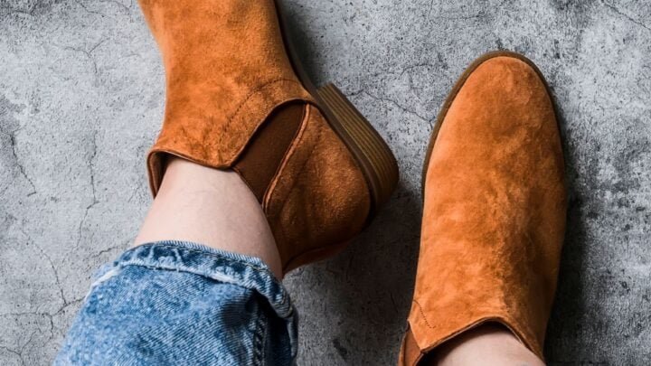 Picture of a woman wearing chelsea boots with jeans.