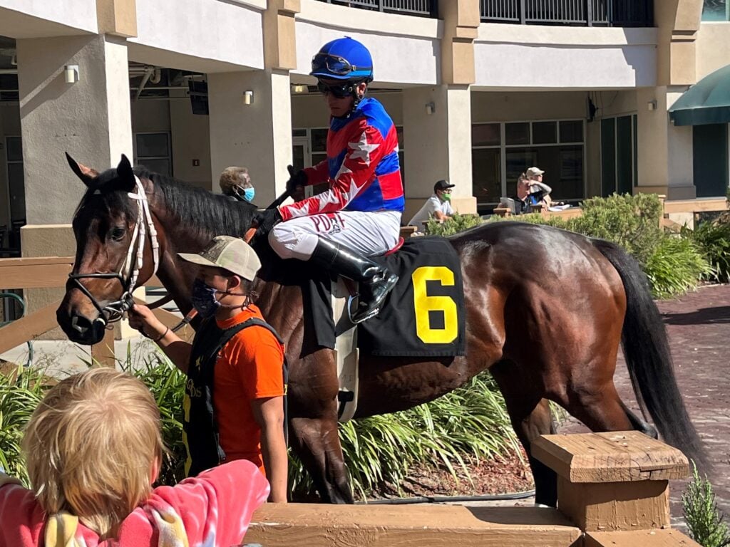 Picture of a jockey to show how their knees are set in English stirrups.