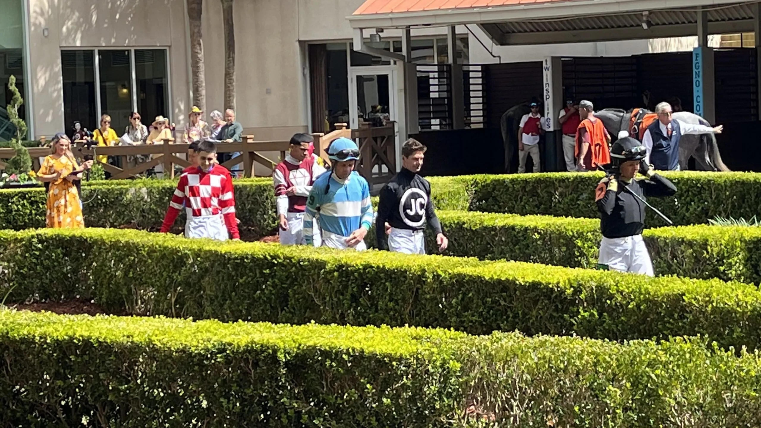 Picture of jockeys in the paddock at the New Orleans Fairgrounds.