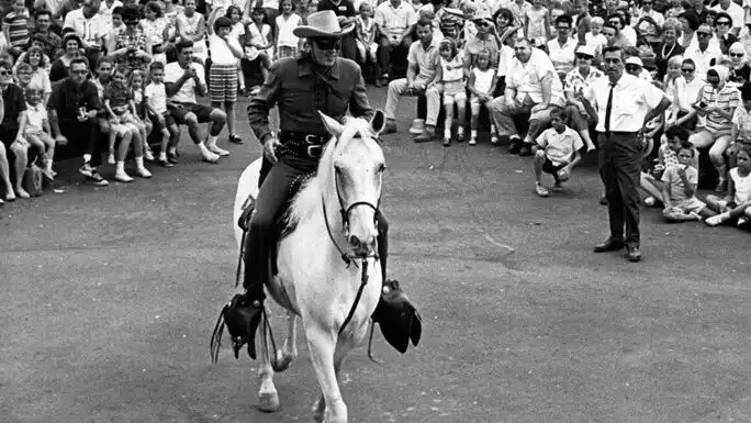 The Lone Ranger riding Silver, his iconic gray horse, in a promotional exhibition. 