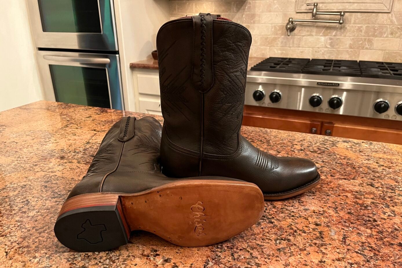 Brown Chisos cowboy boots worn by the author with navy and blue suits