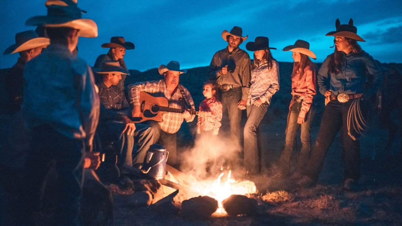 Horse Racing Sense Cowboys and cowgirls wearing cowboy boos while sitting around a campfire.