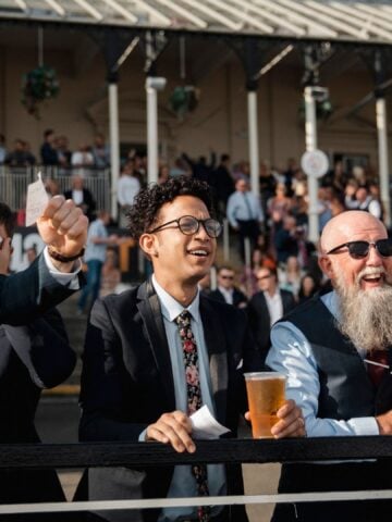 Horse racing crowd cheering at Kentucky Derby