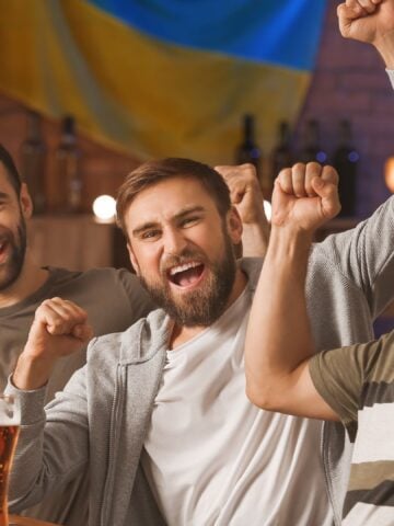Group of bettors celebrating a winning exotic bet at the racetrack