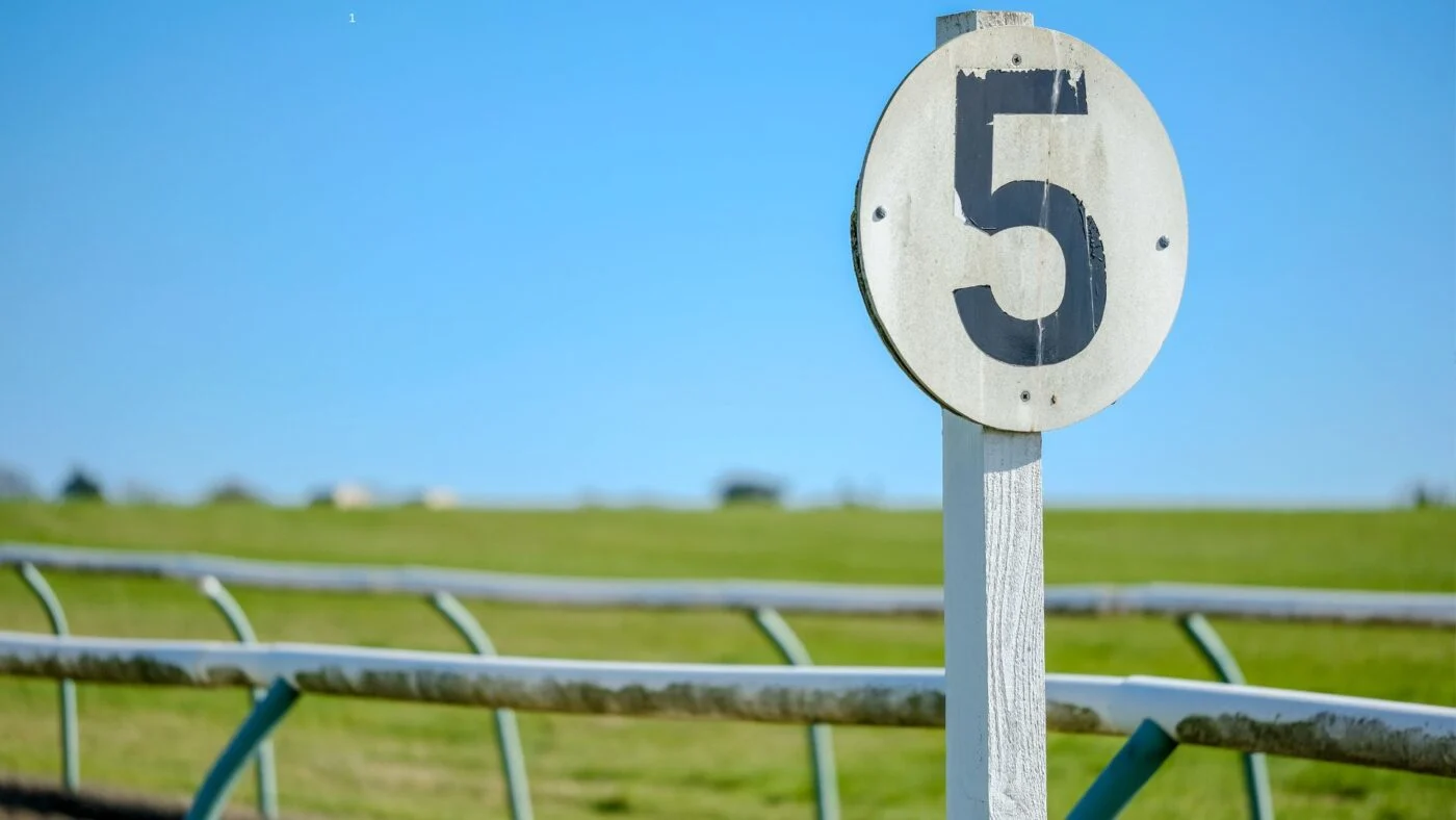 Horse Racing Sense Furlong marker post at a horse racing track, indicating 5/8 mile distance.
