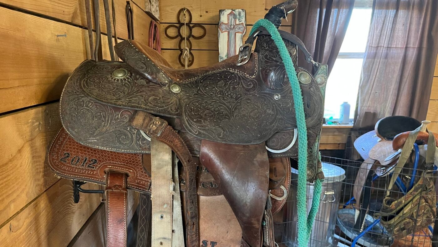 A Western saddle on a saddle rack